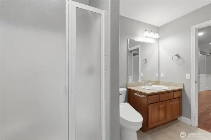 3/4 bath off the main level MIL bedroom and can also be accessed off the hallway. There is also another powder room located at the opposite end of the home.