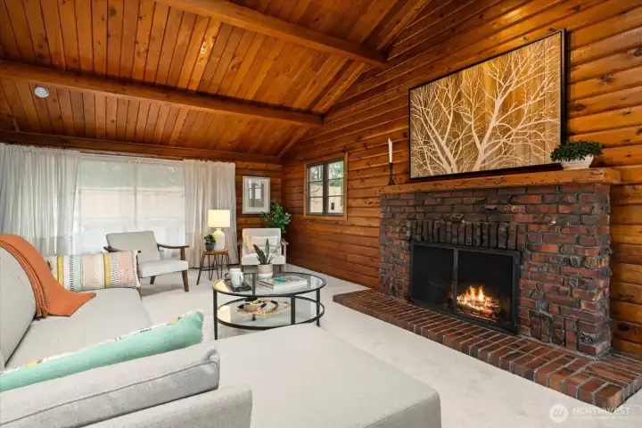 Substantial brick fireplace with hand carved wood mantel radiates warmth and earthiness
