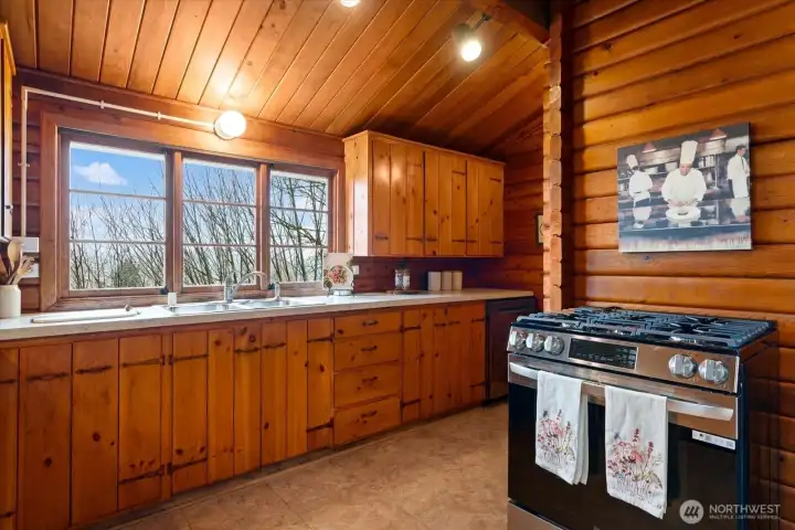 Vaulted kitchen ceiling  and hand made pine cabinets create a natural ambiance in kitchen