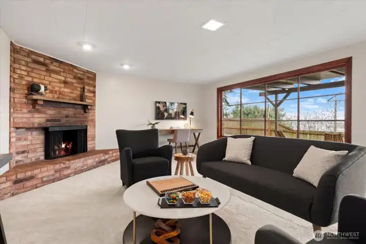 A wall of glass windows in lower rec room provides an abundance of natural light, and offers tree filtered views