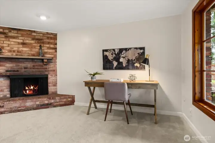 A wood burning fireplace with an rustic brick surround creates a comfortable environment in the lower-level recreation room