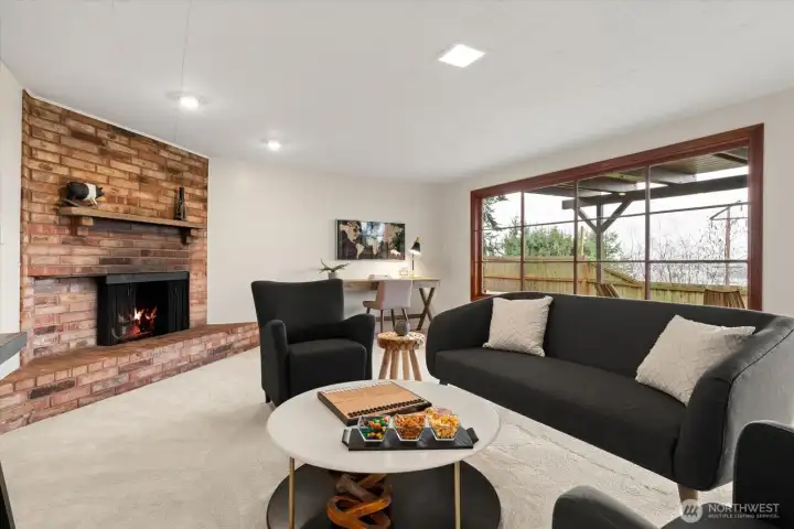 A wall of glass windows in lower rec room provides an abundance of natural light, and offers tree filtered views