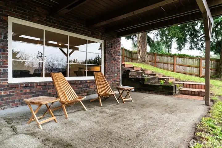 Lower level covered patio, overlooks private, fenced backyard, and offers the perfect shaded spot to enjoy a sunny afternoon sunset
