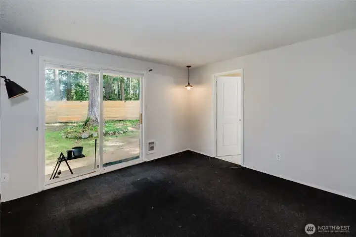 primary bedroom with entry to bathroom and exit to backyard