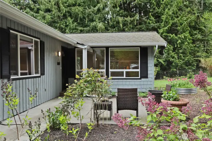 entry offers a flat concrete path and covered porch