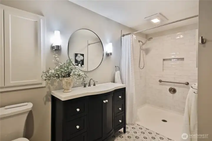 primary bath with walk in shower, beautiful tile floor and elegant fixtures
