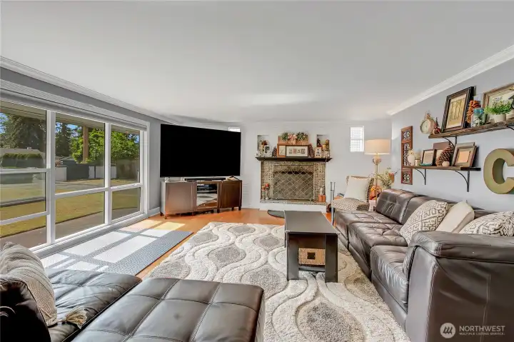 To the left of your front entry is a spacious living room with huge and bright windows as well as a wood burning fireplace for those dark rainy nights.