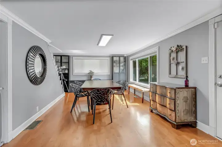 Enter into your beautiful home with your dining room on the right of the entry and your living room on the left. Here you see the front door on the right and you are looking into the dining room that has a beautiful view of the front yard and front garden area.
