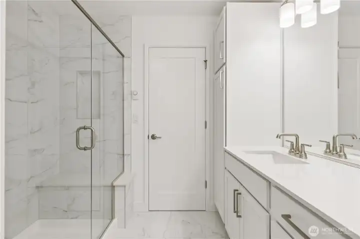 Primary Suite Bathroom with tiled seated shower. Primary Suite Bathroom with tiled seated shower.