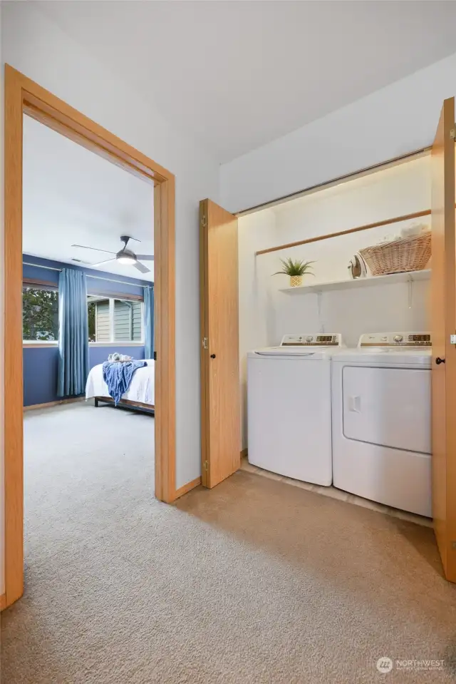 Just off of the loft bonus space, you'll find this conveniently located laundry center behind bifold doors. A light inside reveals the newer Midea washer and dryer set that is included with the home.