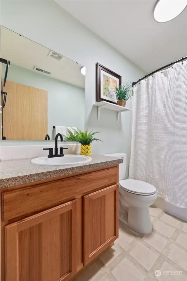 The main bathroom has a full complement of offerings with a bath and shower surround, easy-care vinyl flooring and another BRAND NEW toilet!