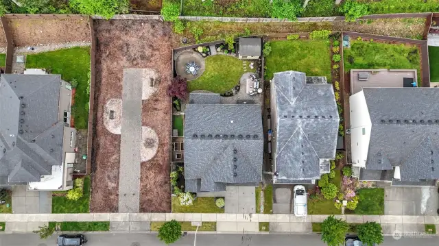 Great aerial view showcases the backyard & the open shared lot next door.