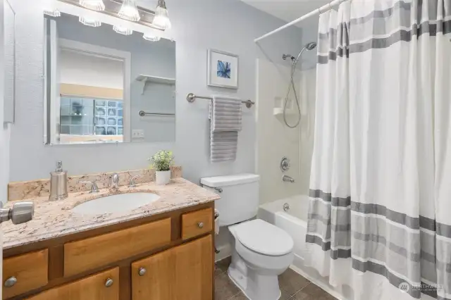 Your private en-suite boasts an upgraded granite vanity and a relaxing bathtub.