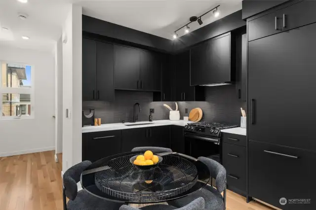 Cook in style with this sleek, all-black kitchen. It has modern appliances and plenty of counter space for culinary creations.