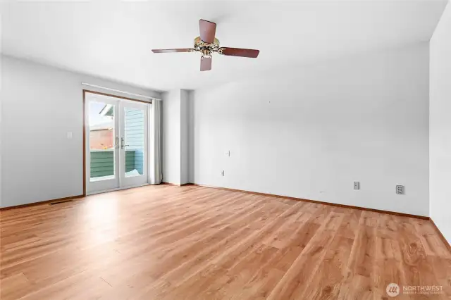 Primary bedroom with French doors leading to deck.