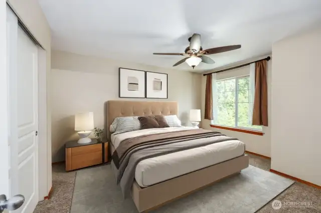 Digitally staged primary suite.