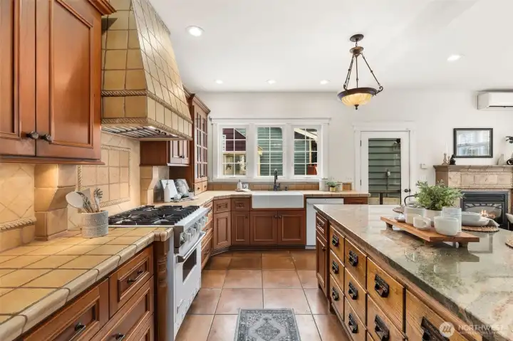 Custom range hood, cherry cabinets, extensive tile details, and high end appliances, a great space for lots of cooking and entertaining.
