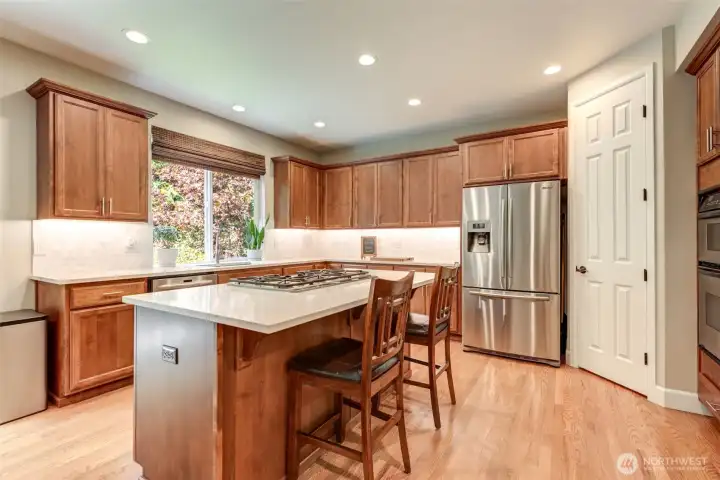 “Kitchen sink window overlooks the private backyard and greenbelt—bringing nature and light into the heart of the home.”