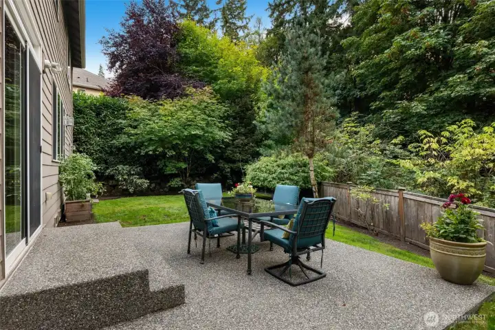 “Sliding door opens to a private backyard with patio and lawn, backed by 6.8 acres of protected greenbelt for lasting privacy.”