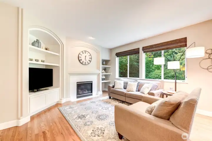 “Living room with gas fireplace, custom built-ins, and charming nooks. A warm, inviting space to relax and gather.”
