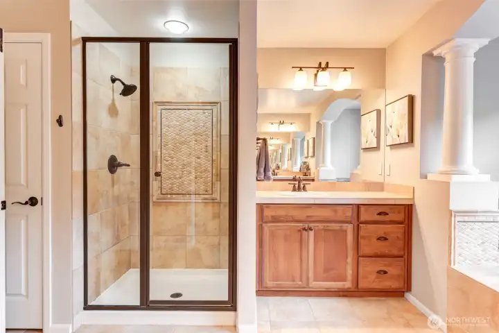“Spa-like en-suite with walk-in shower and dual vanities, offering both style and convenience.”