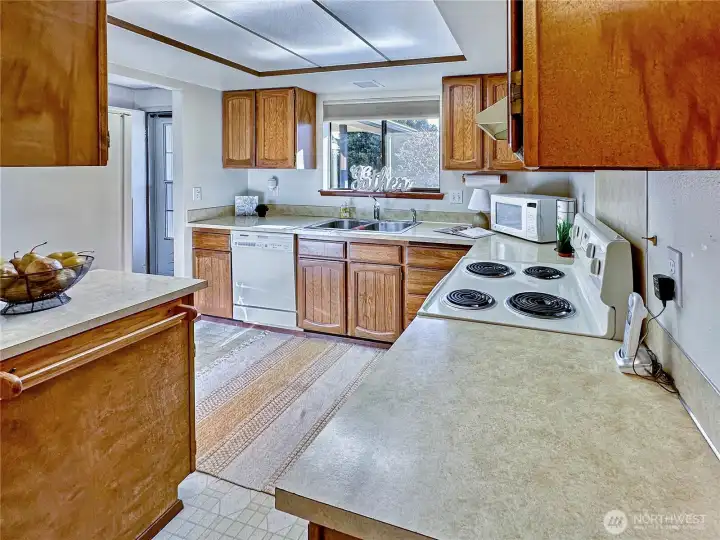 Great walk-through kitchen offering access off the entry, nook, garage and dining areas.  You will love all the counter space.