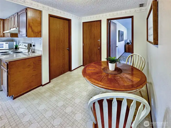 Inviting breakfast nook with access to the dining and family room areas.  The doors in this photo show the access to the interior laundry room and garage.