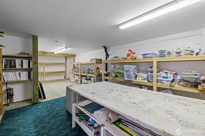 Extra storage space, or work room with extensive shelving  for expansion.