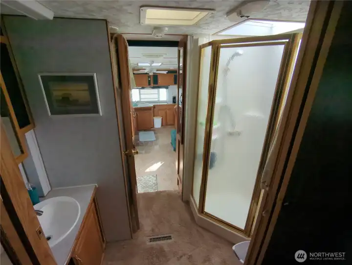 5th wheel bathroom with shower, toilet and sink as well as closet space.