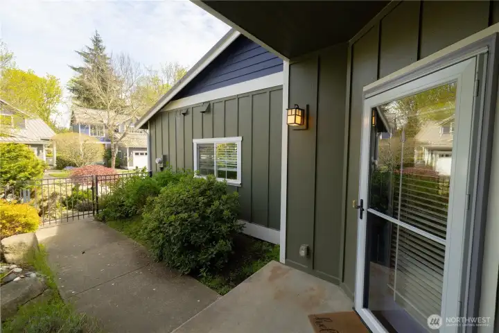 Welcoming and fenced and gated front door entry surrounded by lovely gardens.