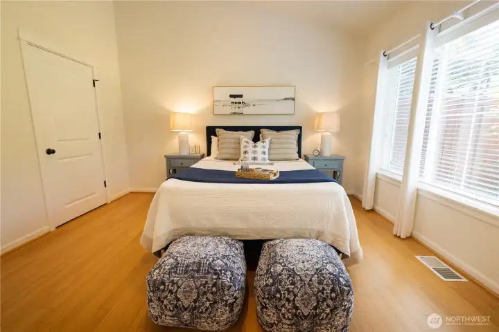 Spacious main floor primary bedroom suite with a walk-in closet and an en-suite bathroom.