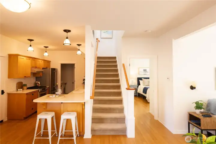 Eat in kitchen with access to the dining room, living room, primary main floor bedroom and ensuite bathroom and stairs leading to the wonderful upper level.