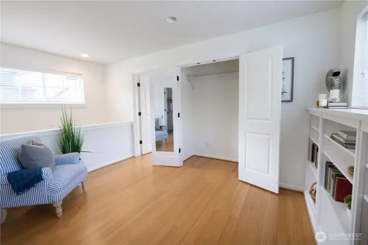 Lovely upper level family room or office/den with closet storage, plus a wall of nice built-in book cases.