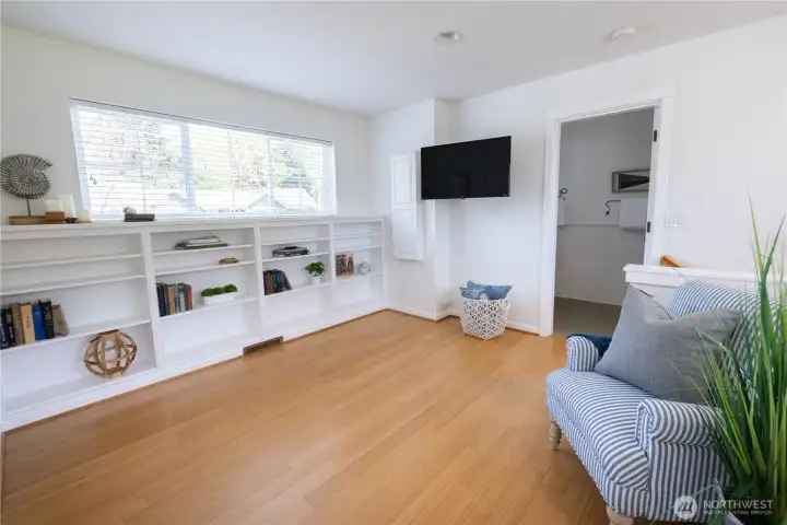 Spacious family room, office or den, with built-in book cases and closet, an adjacent full bathroom tub/shower combination, and beautifully sized second bedroom. The wall mounted LCD screen is one of the two LCD screens that are included in the sale of this beautiful home. This entire upper floor and all it has to offer may be used as an alternative second floor primary bedroom suite, or plenty of room for others including guests.