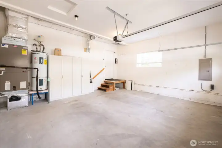 Nice two car attached garage, storage cabinets, garage door opener and a few stairs leading into the house.