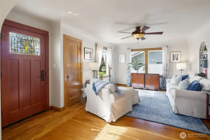 Front door with coat closet and living room