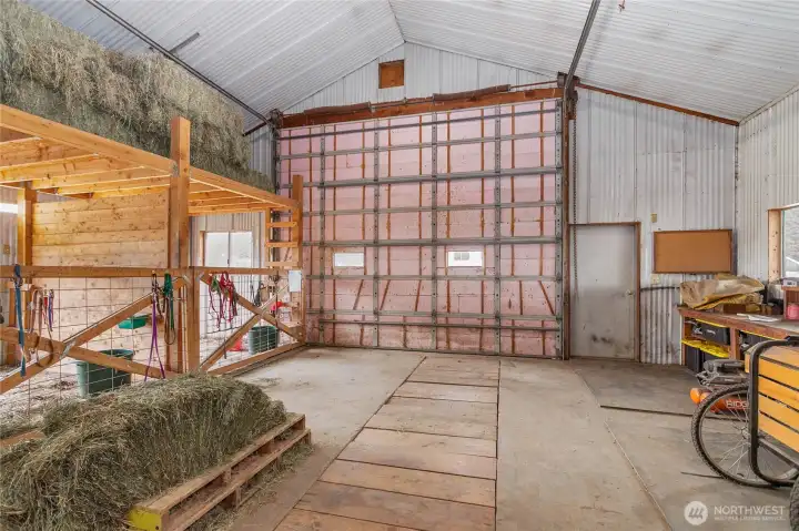 From the office into the shop. Notice the large bay door and the service pit that is covered by boards.