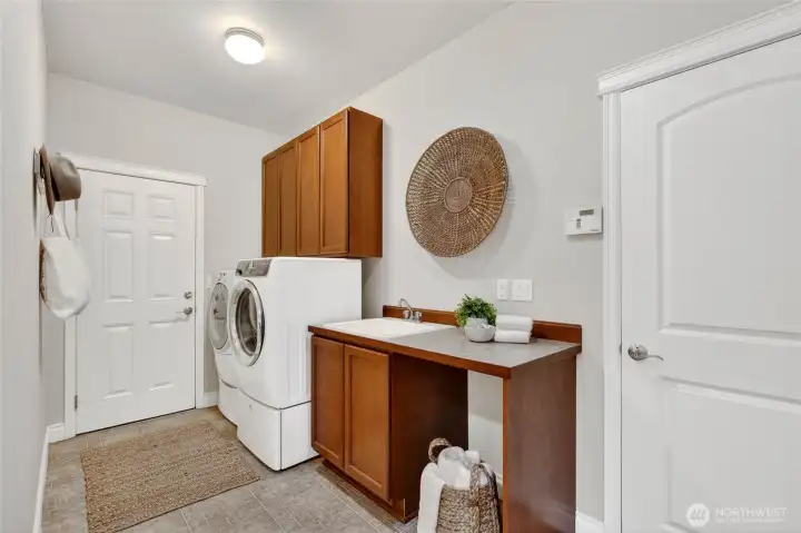 Laundry on the main level with access to garage and outside.