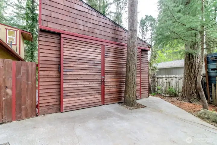 Here's the garage / shop. It will fit a car if desired with lots of extra space for whatever you need it for. There's also a toilet drain in here, but no toilet installed.