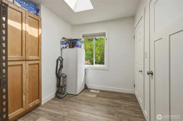 Large utility room with washer and dryer space in its own room.