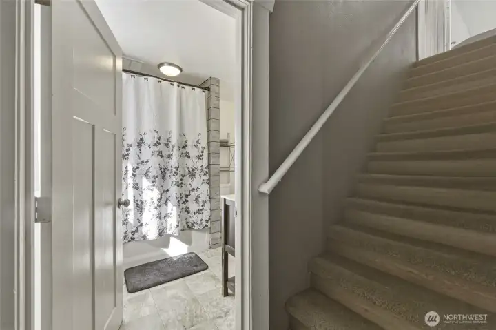 Stair way up to primary bedroom and another bedroom.