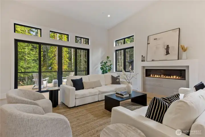Wooded view form the living room with sliding doors opening to the deck