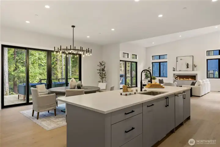 Quartz Island and dining area with sliding doors to the deck for indoor/outdoor entertaining