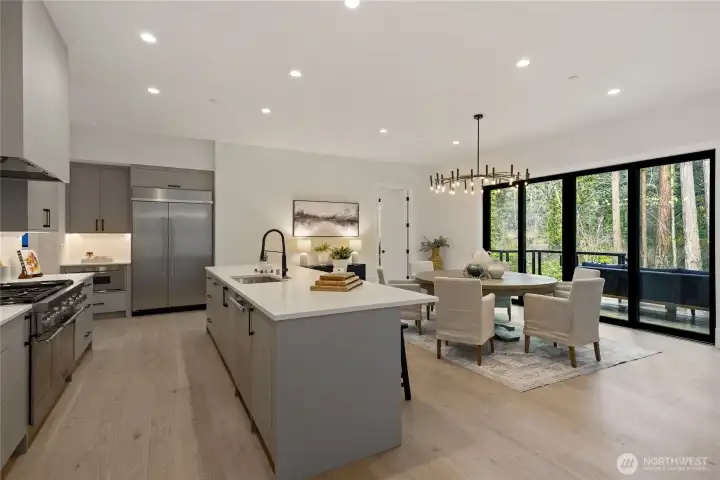Kitchen and dining with views into the woods