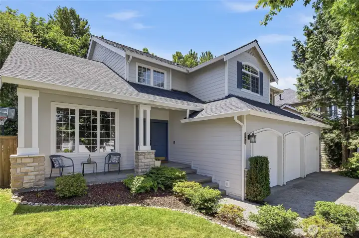 Beautiful curb appeal with its double door entry and front sitting area and greenery
