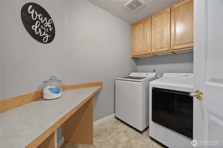 Utility room downstairs with a space for folding laundry