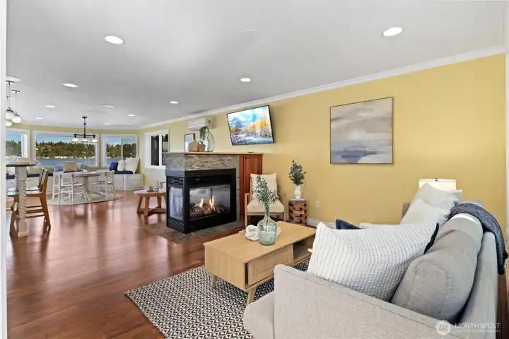 Thoughtfully crafted interiors feature gleaming bamboo hardwood floors, a dramatic multi-sided gas fireplace, expansive view windows, and seamless indoor-outdoor living.