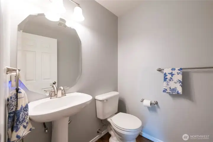 Powder room right off the laundry room, front entry