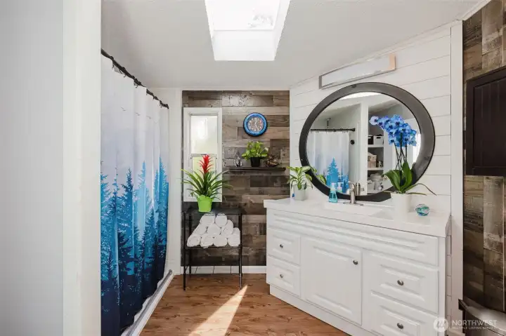 Primary Bath was recently remodeled with upgraded custom wood work, newer laminate wood flooring, updated vanity, and deep roll-in shower. Primary Bath was recently remodeled with upgraded custom wood work, newer laminate wood flooring, updated vanity, and deep roll-in shower.