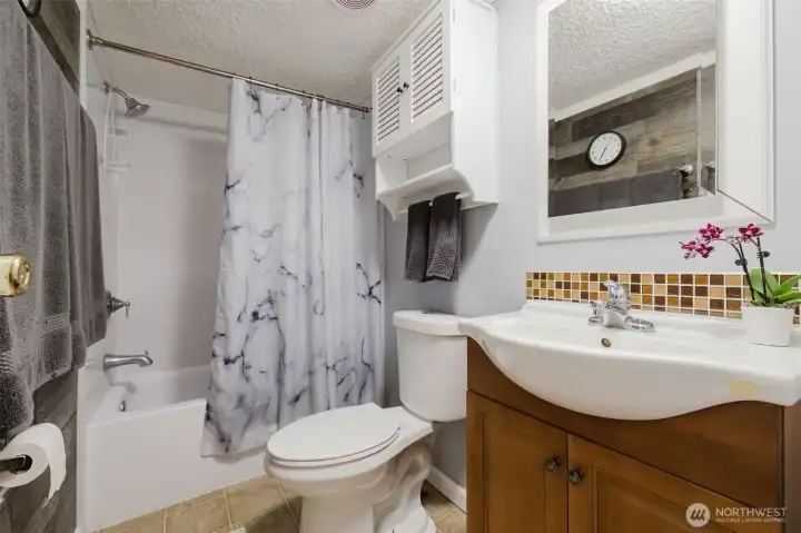 Second bedroom has newer vanity, accent wall, and more. Second bedroom has newer vanity, accent wall, and more.